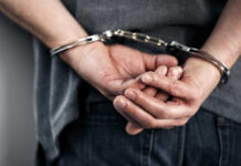 Hidden Law Triggers Life Sentence—What’s Missing? Hands cuffed behind the back, indicating arrest