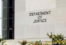 DOJ’s SHOCKING Move Against Anti-ICE Violence Sign on the exterior wall of the Department of Justice building