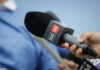 A hand holding a CNN microphone during a news interview