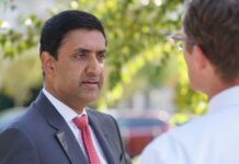 Dem Civil War Erupts Over Laken Riley Two professionals engaged in a conversation outdoors
