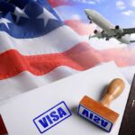 Visa stamp and travel documents on an American flag background with an airplane in the sky