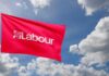Reform UK Surges: Labour’s Nightmare Begins Red flag with 'Labour' logo waving against a cloudy sky