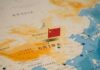 Map of China with a small Chinese flag placed on it