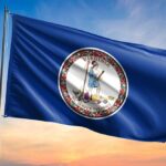 Virginia state flag waving against a sunset sky