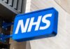 Massive NHS Reforms — Chaos and Confusion! NHS sign displayed prominently on a building