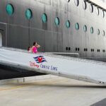 Passengers boarding a Disney cruise ship via a ramp