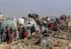 Gaza Horror: Surgeon’s Shocking Testimony Exposed Displaced families with belongings crowd a rubble-strewn road