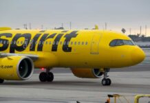 A yellow Spirit Airlines airplane on the runway