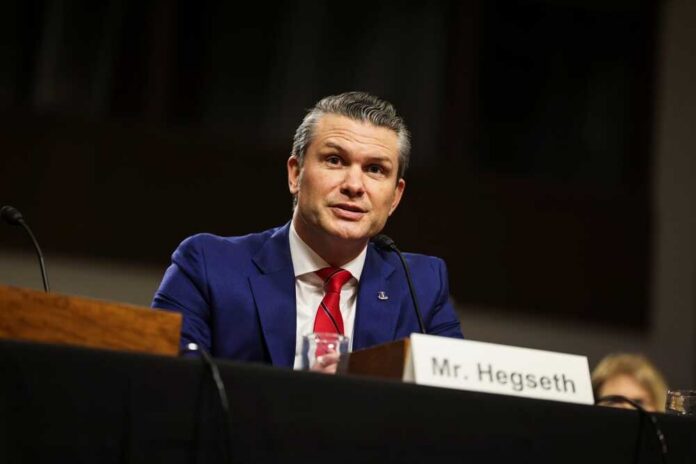 Man in a blue suit speaking at a government hearing