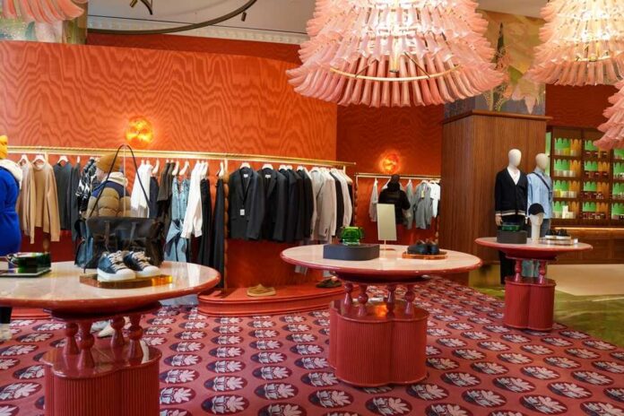 shutterstock_2604332617.jpg A stylish clothing store interior featuring racks of apparel and decorative tables