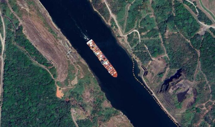 Panama,Canal:,High-resolution,Aerial,View,Of,Global,Trade,And,Engineering Aerial view of a cargo ship navigating a river surrounded by greenery
