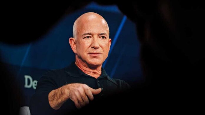 Bald man in a black shirt speaking on stage