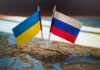 Ukrainian and Russian flags pinned on a map of Eastern Europe