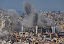 Smoke rising from buildings in a densely populated urban area