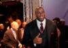 A man in a suit giving a thumbs up at a red carpet event