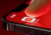 YouTuber Charged in Double Death Case Finger tapping YouTube app icon on smartphone screen