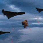 Three military drones fly through a cloudy sky amid anti-air fire