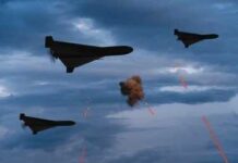 Three military drones fly through a cloudy sky amid anti-air fire