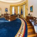 Trump’s Oval Office Gets Golden Makeover A political figure looking upward beside an American flag