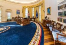 Trump’s Oval Office Gets Golden Makeover A political figure looking upward beside an American flag