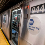 New York City subway train at a station with open doors