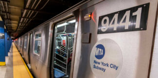 New York City subway train at a station with open doors