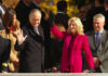 High Bail, Zero Details—What’s Being Hidden? Two public figures waving at an outdoor event surrounded by a crowd