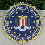 FBI seal featuring the Department of Justice emblem on a wall