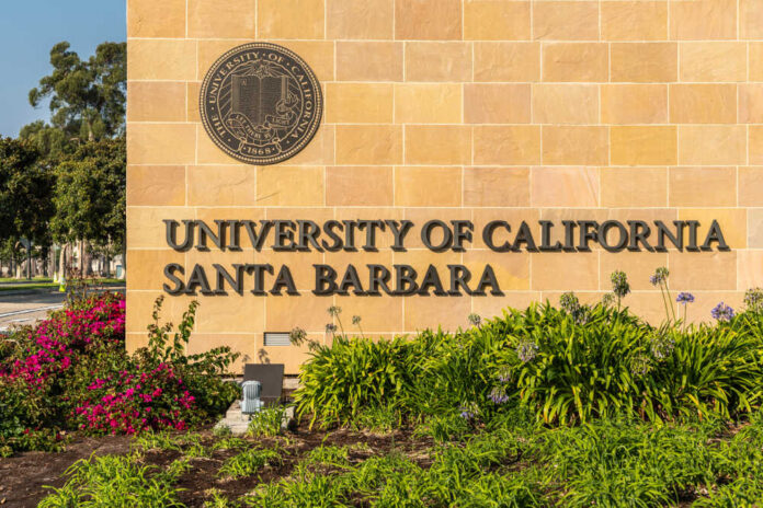 University entrance sign with seal and landscaping