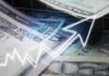 Close-up of U.S. dollar bills with a rising graph overlay