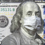 A hundred dollar bill featuring Benjamin Franklin wearing a face mask