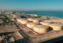 Gas Prices Ease As Peace Talks Advance Aerial view of large oil storage tanks near a coastal area