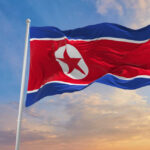 North Korean flag waving against a blue sky
