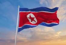 North Korea Turns Naval Failure Into Warning North Korean flag waving against a blue sky