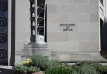 Protesters Or Criminals? Court Battle Begins Facade of a government building featuring the American flag and decorative entrance