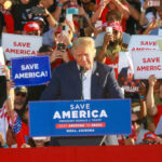 GOP Civil War Erupts Over Voting Crackdown Donald Trump speaking at a political rally with supporters holding signs