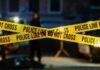 Wrong Order Erupts Into Knife Chaos Police tape marking a crime scene with blurred figures in the background