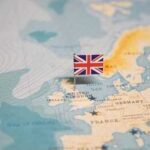 Party Revolt Ends Prime Minister’s Run A map of Europe with a small flag of the United Kingdom pinned on it