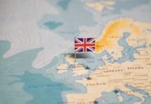 Party Revolt Ends Prime Minister’s Run A map of Europe with a small flag of the United Kingdom pinned on it