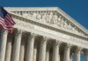 Alabama Map Fight Upended by SCOTUS United States Supreme Court facade with flag and Corinthian columns