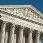 Alabama Map Fight Upended by SCOTUS United States Supreme Court facade with flag and Corinthian columns