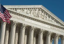 United States Supreme Court facade with flag and Corinthian columns
