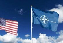 Europe Exposed As U.S. Steps Back Flags of various nations displayed outside NATO headquarters under a clear blue sky