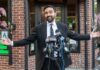 Noncitizen Voting Fight Ignites NYC Man in a suit speaking at a press conference with microphones in front of him