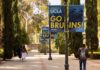 Dorm Attacks Rock UCLA—Mystery Deepens students walking along a tree-lined campus walkway with blue banners on lampposts