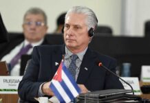 Treasury Freezes Cuba’s Top Boss Cuban leader at a political meeting wearing headphones