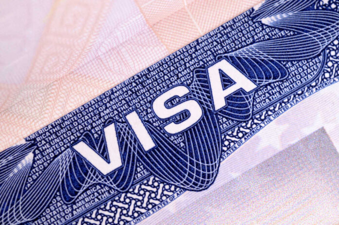 shutterstock_503763646 Close-up of a visa document showing the word VISA and intricate design elements