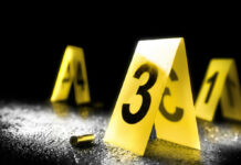 Pool Day Horror Leaves Children Wounded Yellow evidence markers with numbers at a crime scene alongside a bullet casing