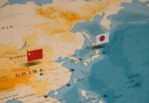Tensions Rise Near Disputed Islands Japanese flag with a red circle on a white background waving against a blue sky
