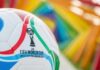 Soccer ball with World Cup logo against a colorful background